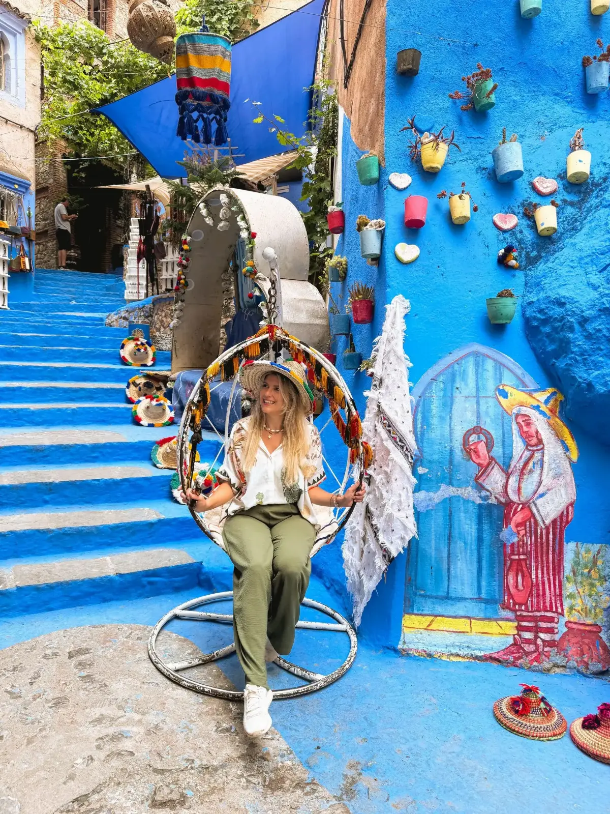 Blue street with an orange door in Chefchaouen on a tour with Traveling Morocco