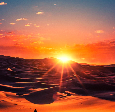 10 Days in Morocco from Fes – Sahara Desert camel trek at sunset near Merzouga dunes on a Morocco desert tour.